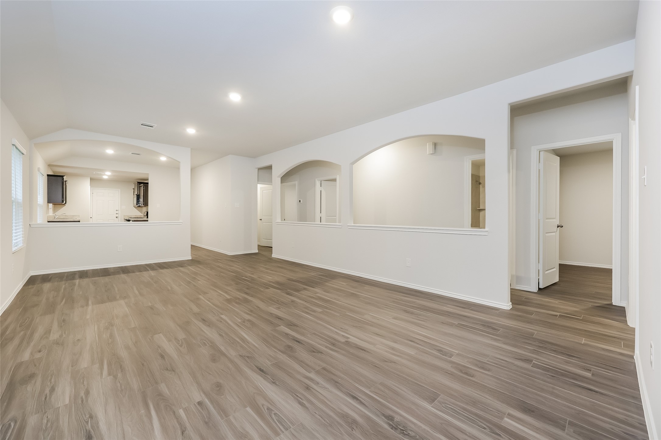 22211 Red Knot Run Splendora, TX 77372 - Photo 3 of 18 an empty room with wooden floor and windows