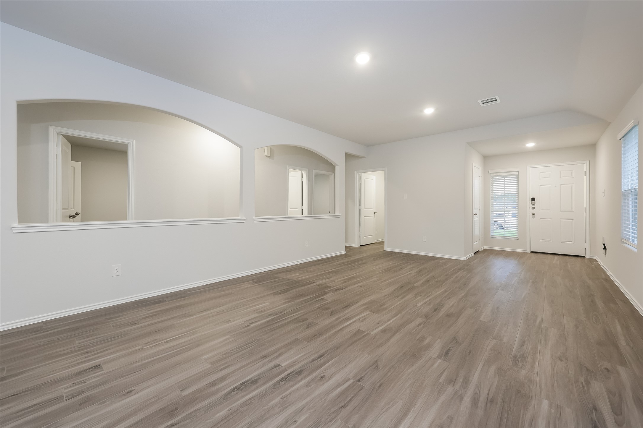 22211 Red Knot Run Splendora, TX 77372 - Photo 4 of 18 an empty room with wooden floor and windows