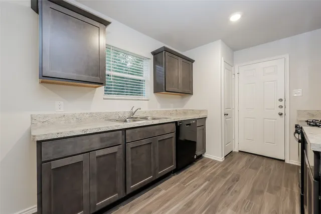 a kitchen with stainless steel appliances granite countertop a sink stove and cabinets