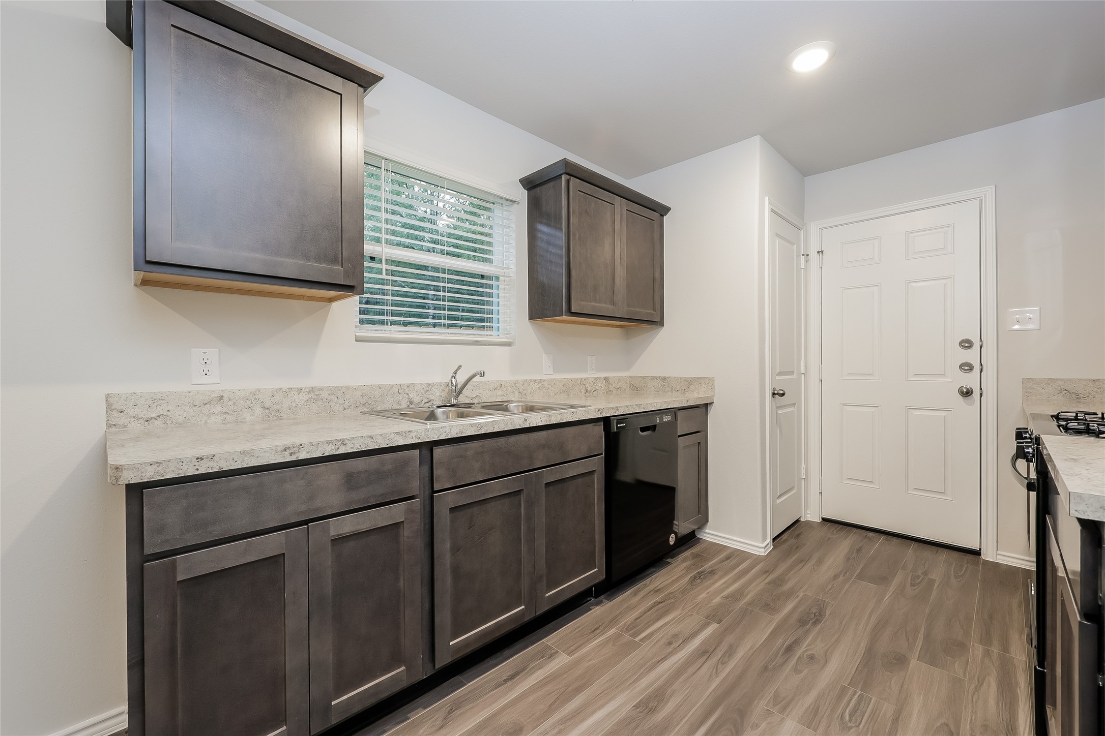 22211 Red Knot Run Splendora, TX 77372 - Photo 5 of 18 a kitchen with stainless steel appliances granite countertop a sink stove and cabinets