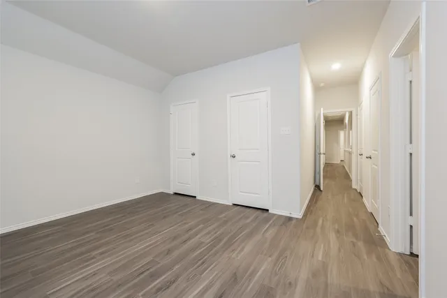 wooden floor in a hall with an empty room