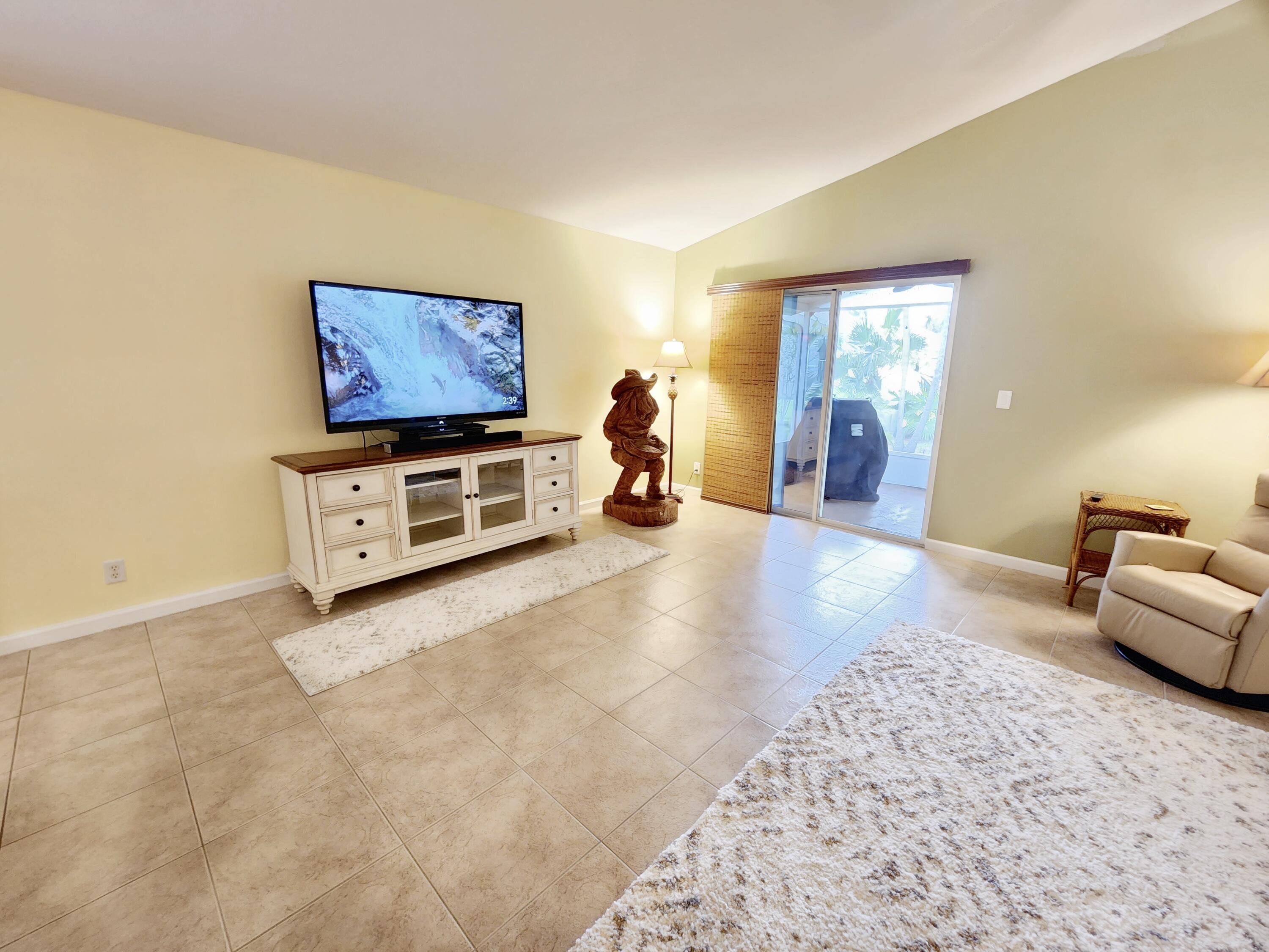 2584 Southwest Impala Way Stuart, FL 34997 - Photo 36 of 72 Great room leads to backyard