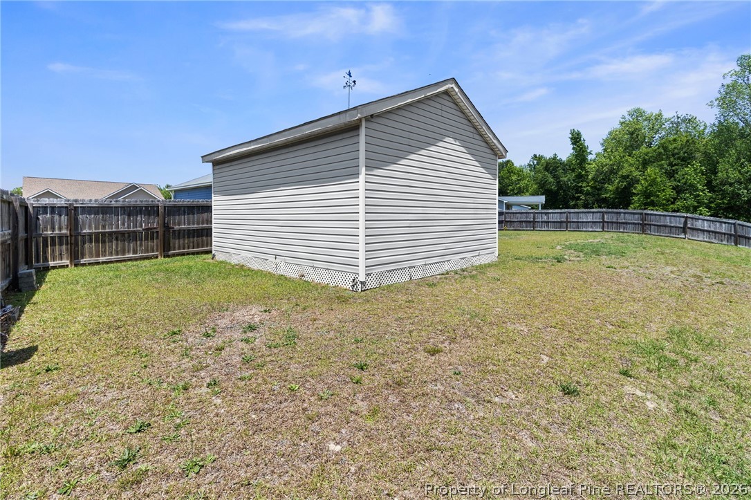 216 Meherrin Loop Raeford, NC 28376 - Photo 35 of 38 a view of a backyard with a garden and barbeque grill