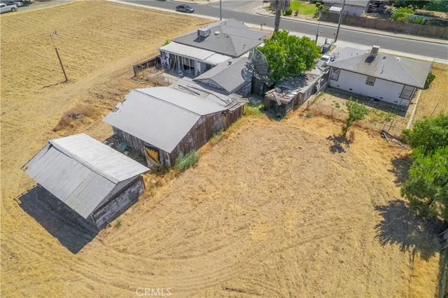an aerial view of residential house with parking