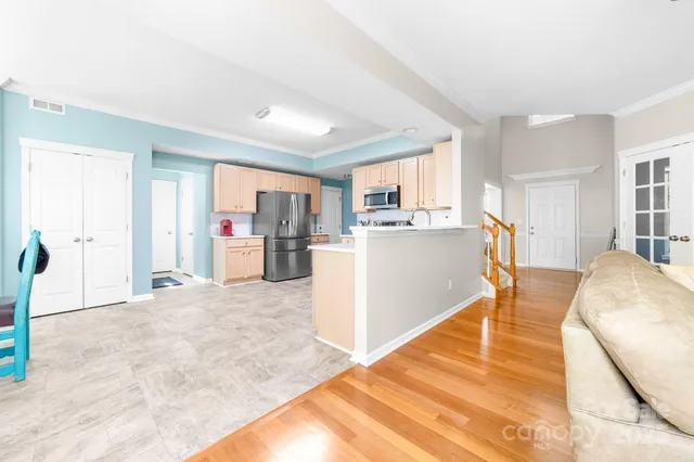 a view of kitchen with furniture and wooden floor