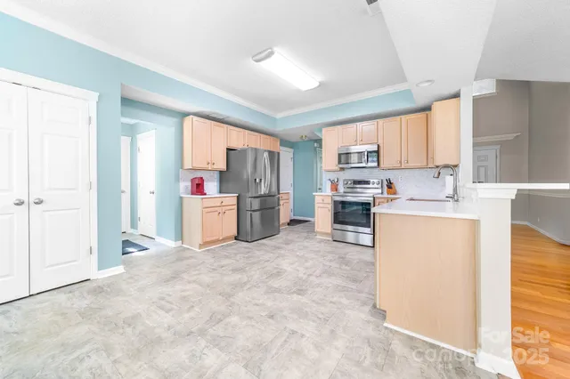 a kitchen with a refrigerator and a stove top oven