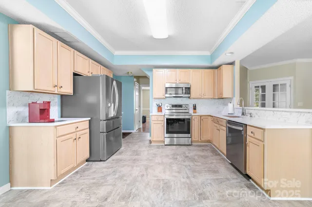 a kitchen with stainless steel appliances granite countertop a refrigerator sink and stove