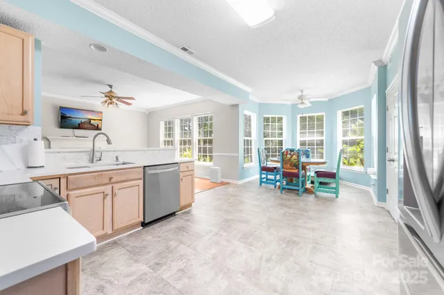a kitchen with sink and chairs