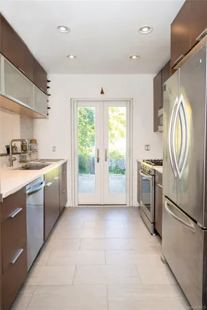 a kitchen with a refrigerator sink and cabinets