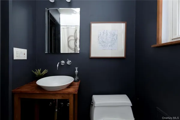 a bathroom with a toilet a sink and mirror