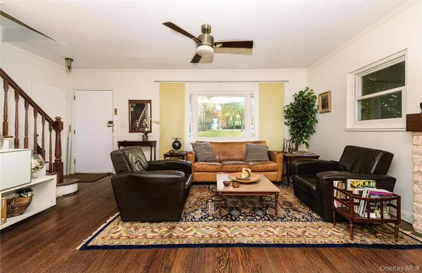 a living room with furniture rug and window