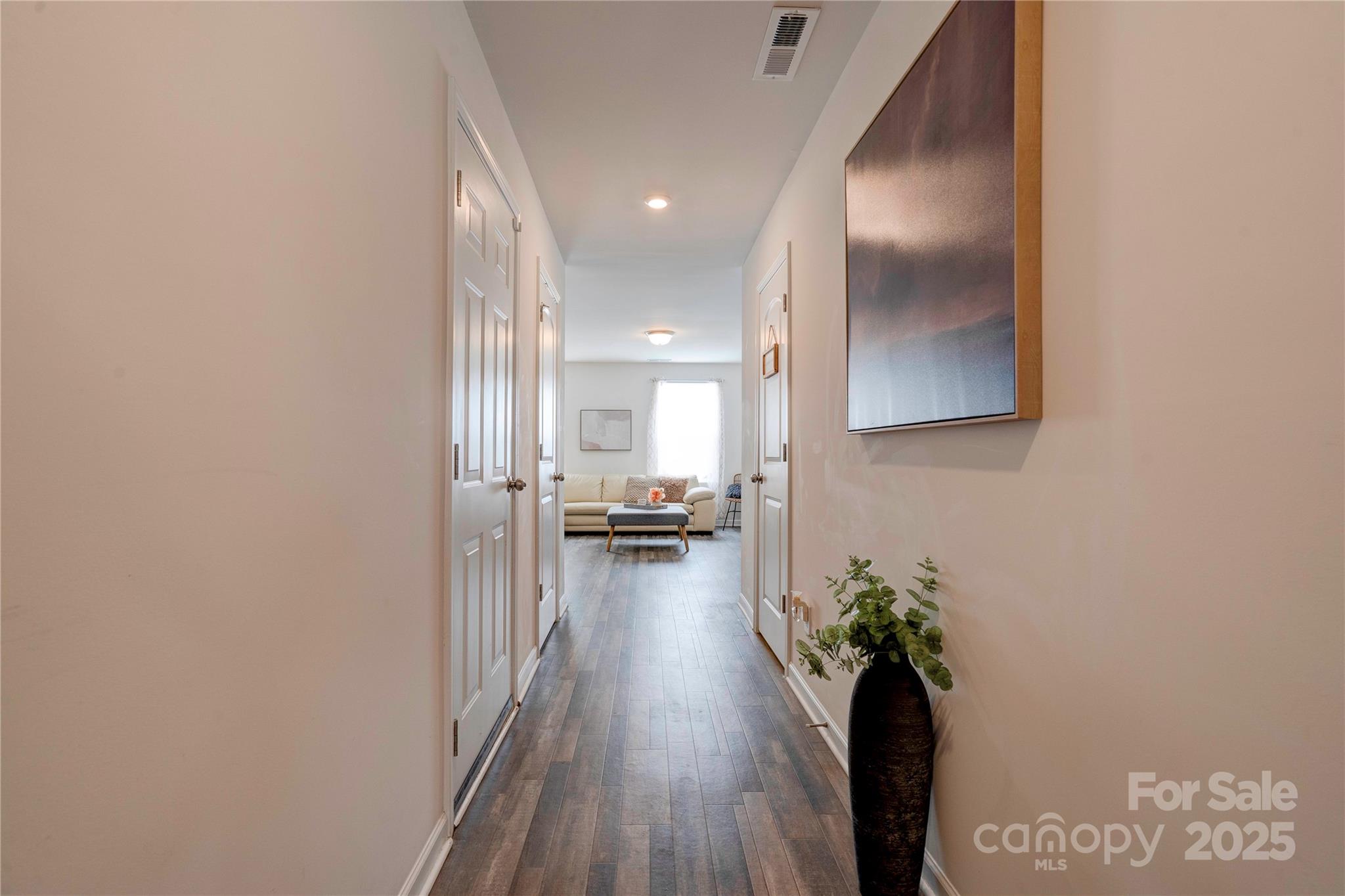 2344 Joes Lake Road Shelby, NC 28152 - Photo 19 of 47 a view of a hallway with wooden floor and a potted plant