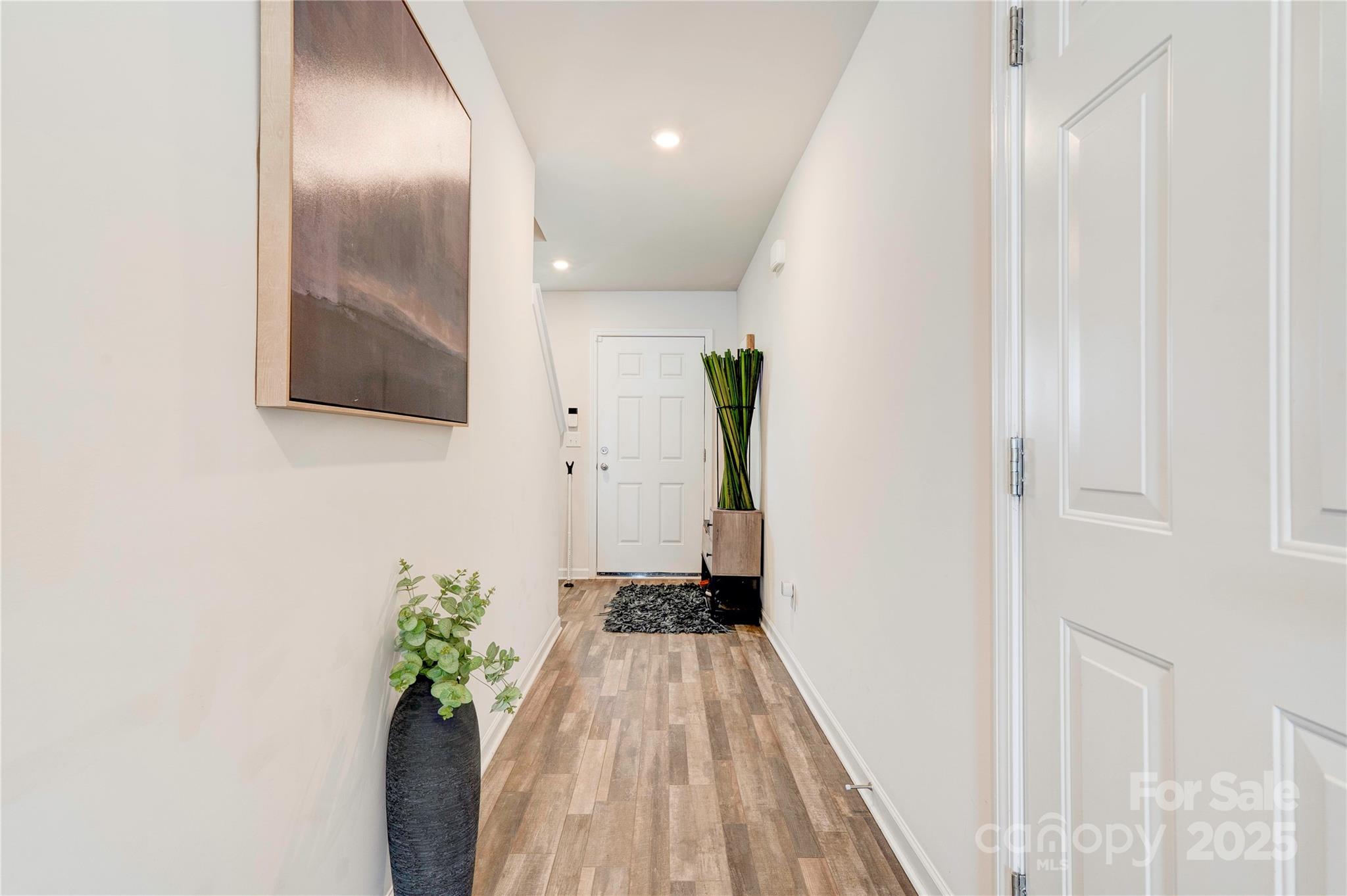 2344 Joes Lake Road Shelby, NC 28152 - Photo 20 of 47 a view of a hallway with wooden floor and a potted plant