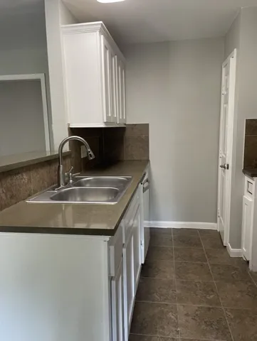 a kitchen with a sink and cabinets
