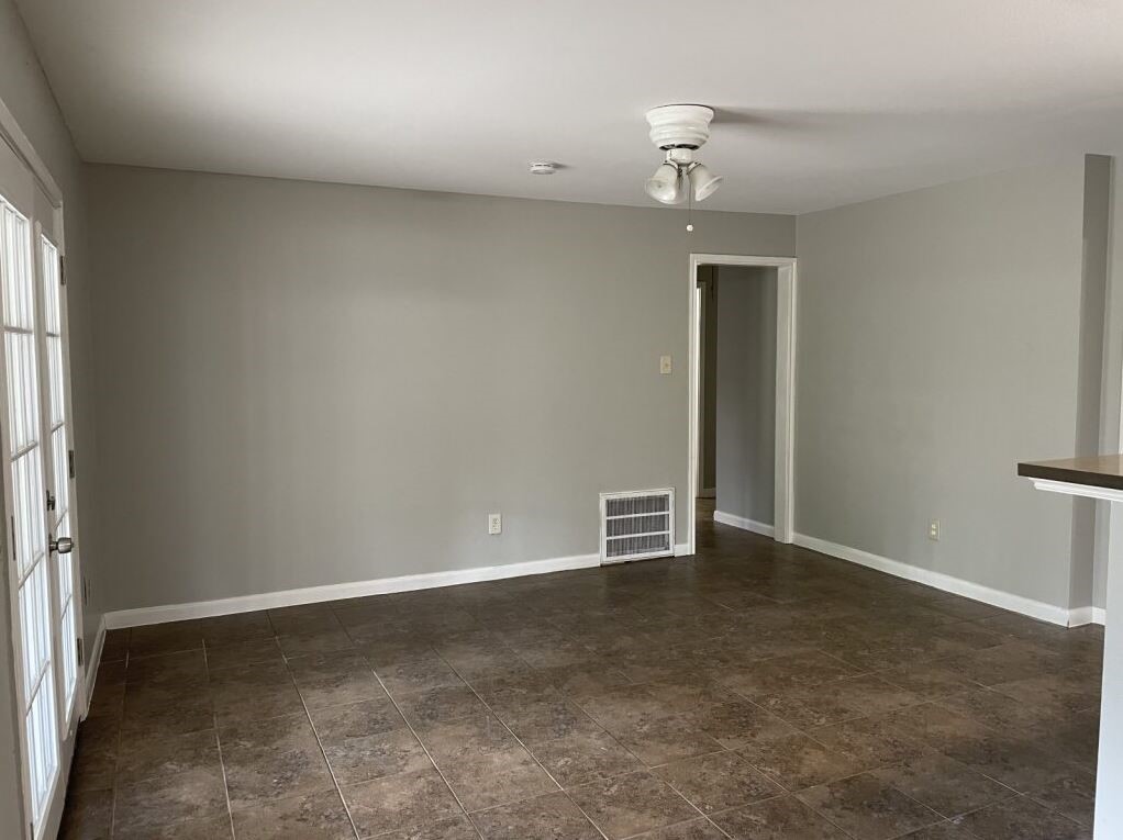 10715 Segrest Drive Houston, TX 77047 - Photo 4 of 9 an empty room with an entryway and fan
