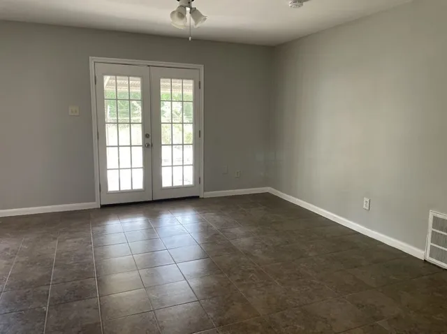 an empty room with a empty space and windows