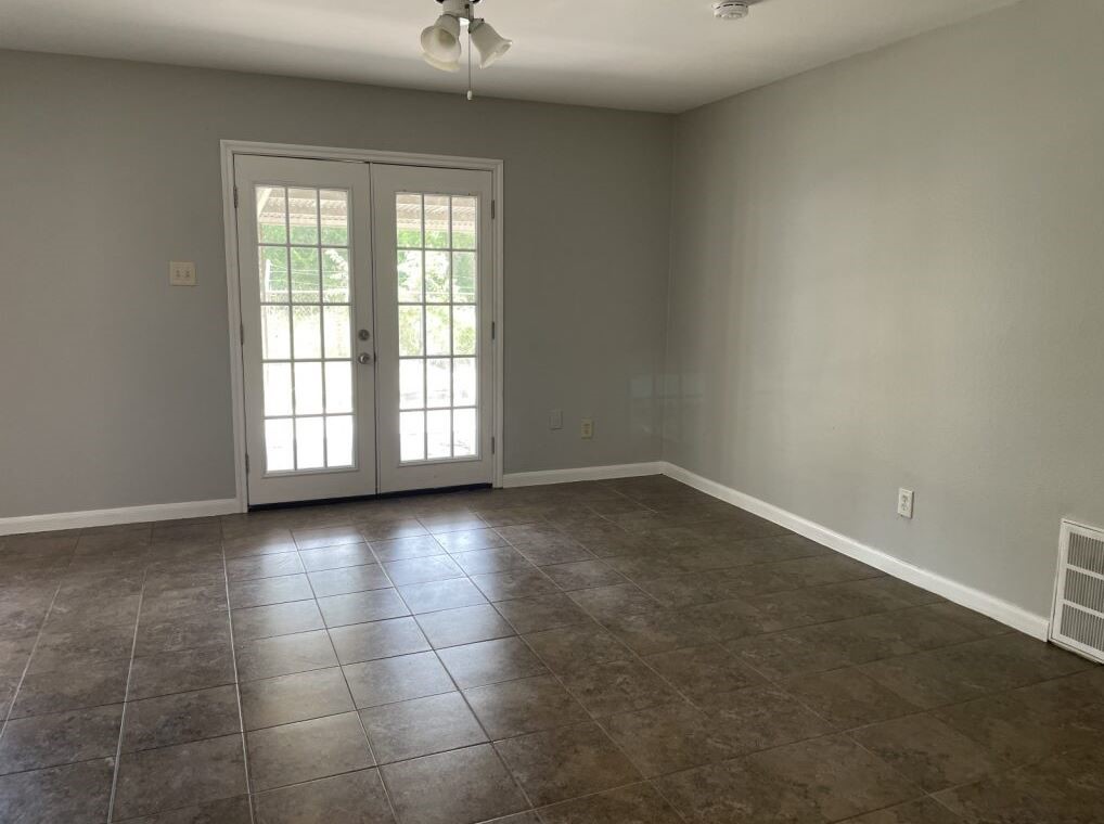 10715 Segrest Drive Houston, TX 77047 - Photo 5 of 9 an empty room with a empty space and windows
