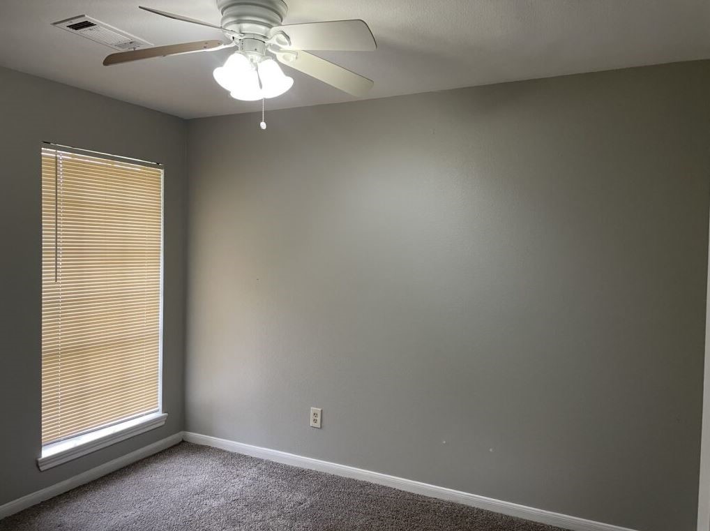 10715 Segrest Drive Houston, TX 77047 - Photo 7 of 9 an empty room with a window and a fan