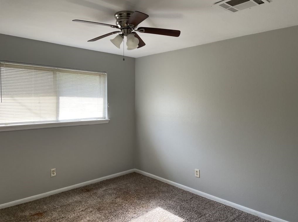 10715 Segrest Drive Houston, TX 77047 - Photo 9 of 9 an empty room with a window and a fan