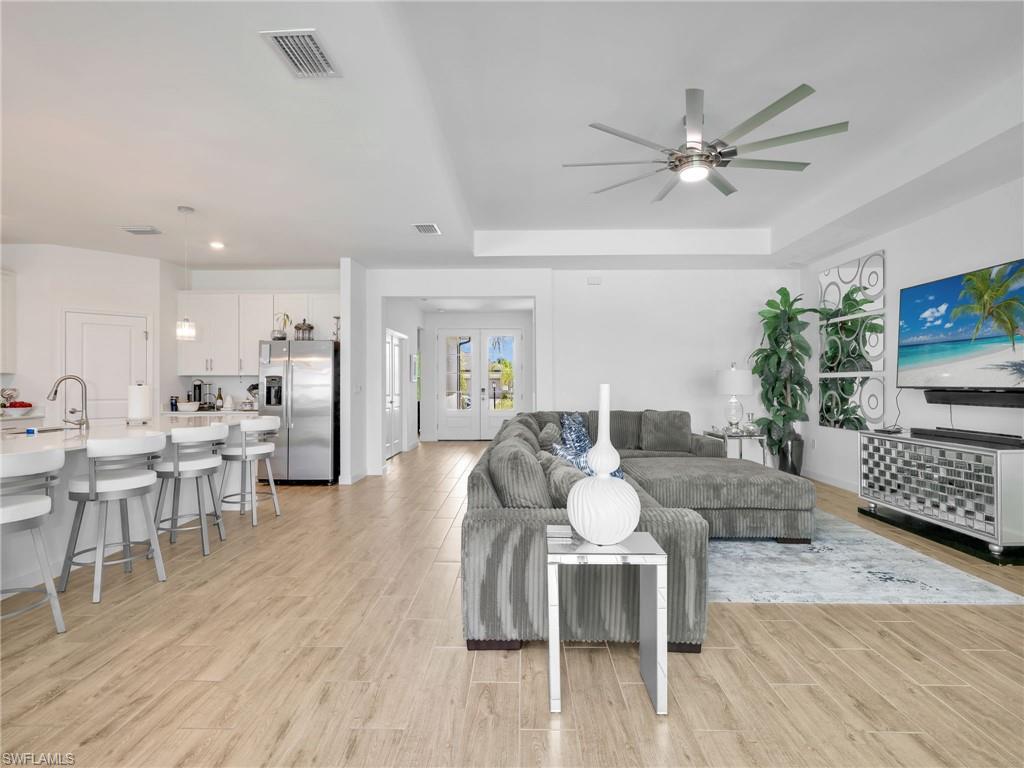 18278 Ridgeline Drive Estero, FL 33928 - Photo 11 of 45 a living room with furniture wooden floor and a flat screen tv