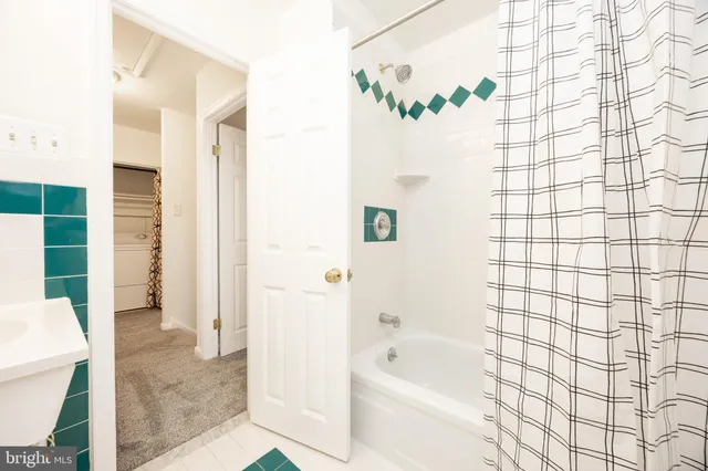 a bathroom with a bathtub and shower