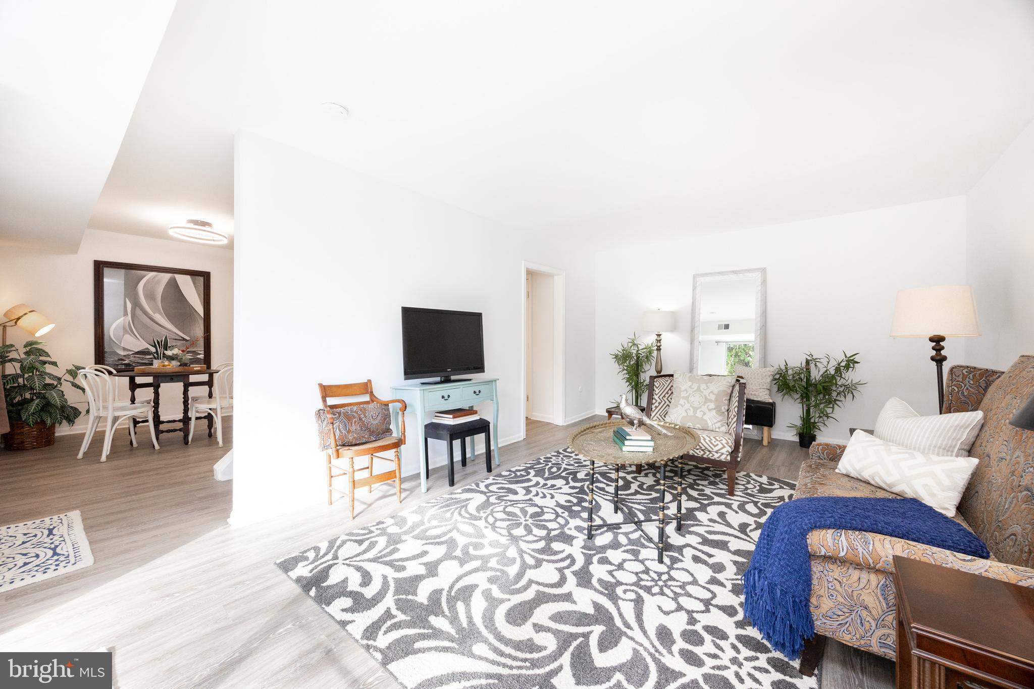 1518 Manley Road, Unit B17 West Chester, PA 19382 - Photo 7 of 25 a living room with furniture a flat screen tv and a table