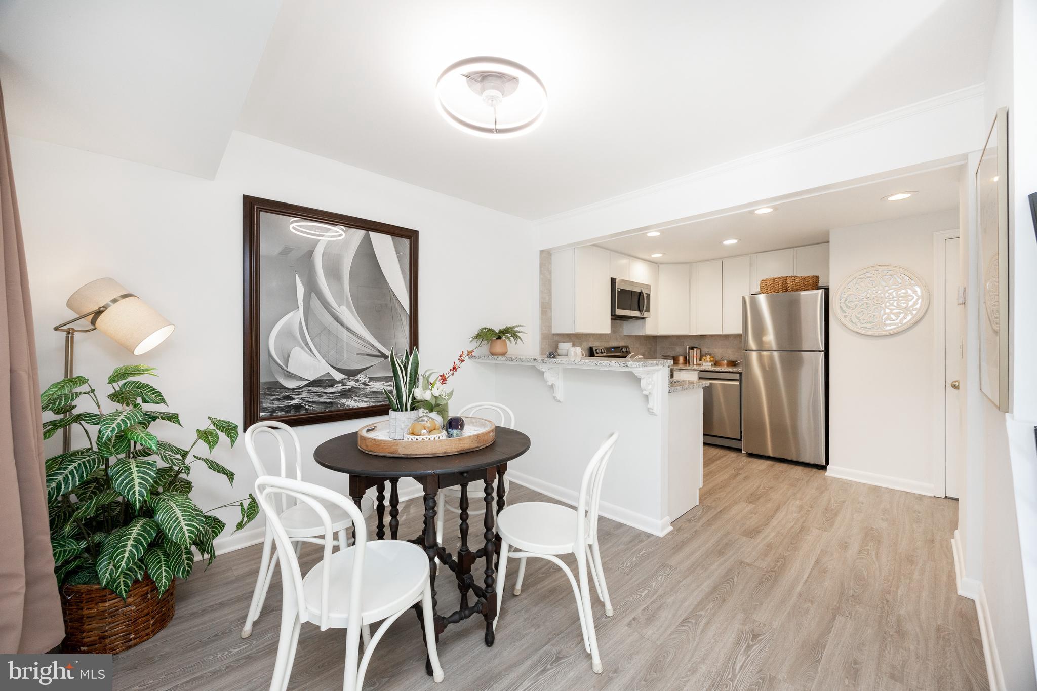 1518 Manley Road, Unit B17 West Chester, PA 19382 - Photo 8 of 25 a view of a dining room with furniture and wooden floor