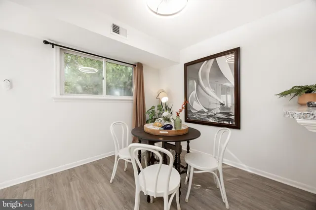 a view of a dining room with furniture window and wooden floor