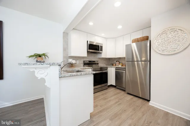 a kitchen with a refrigerator sink and a stove