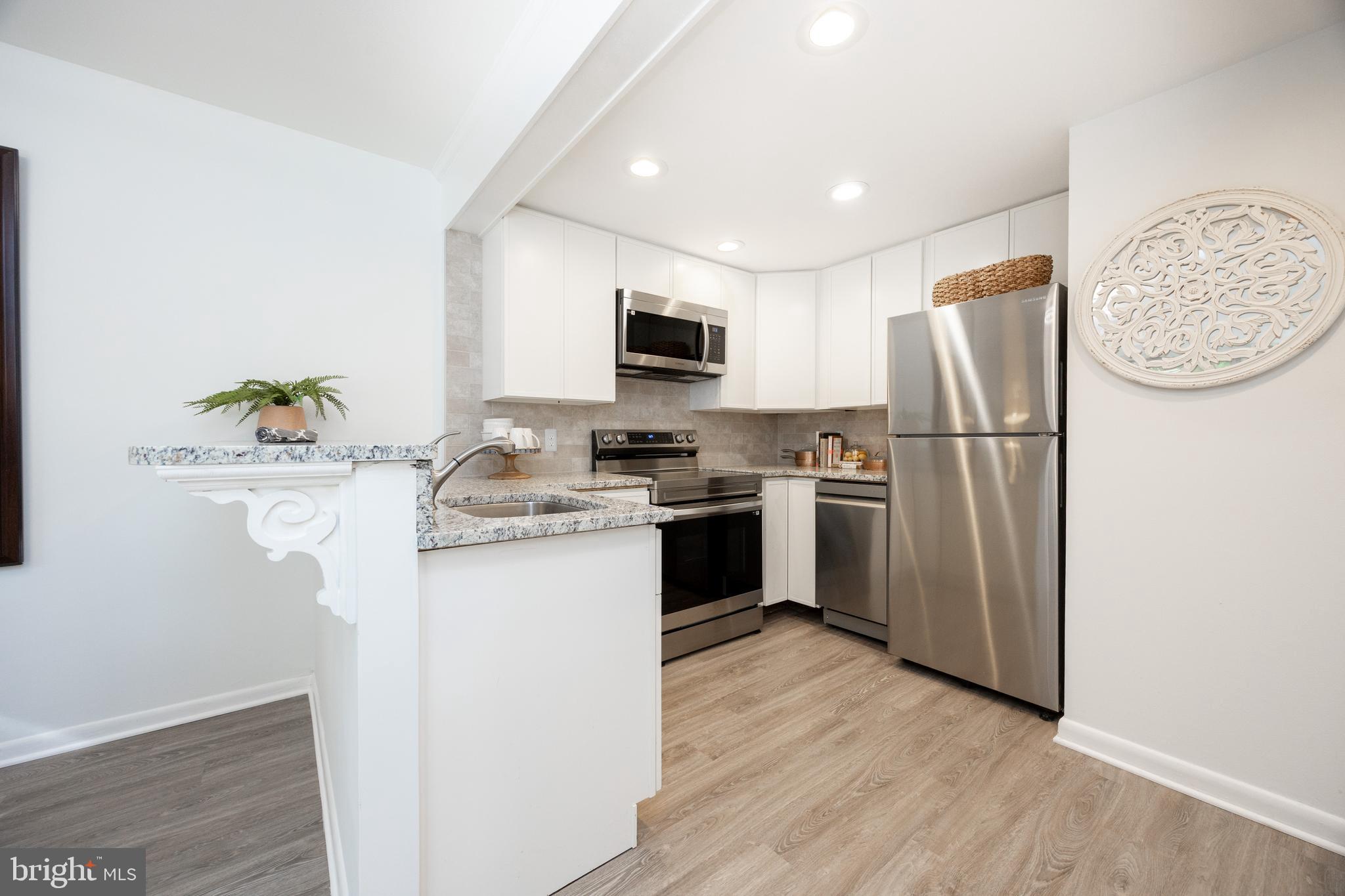 1518 Manley Road, Unit B17 West Chester, PA 19382 - Photo 10 of 25 a kitchen with a refrigerator sink and a stove