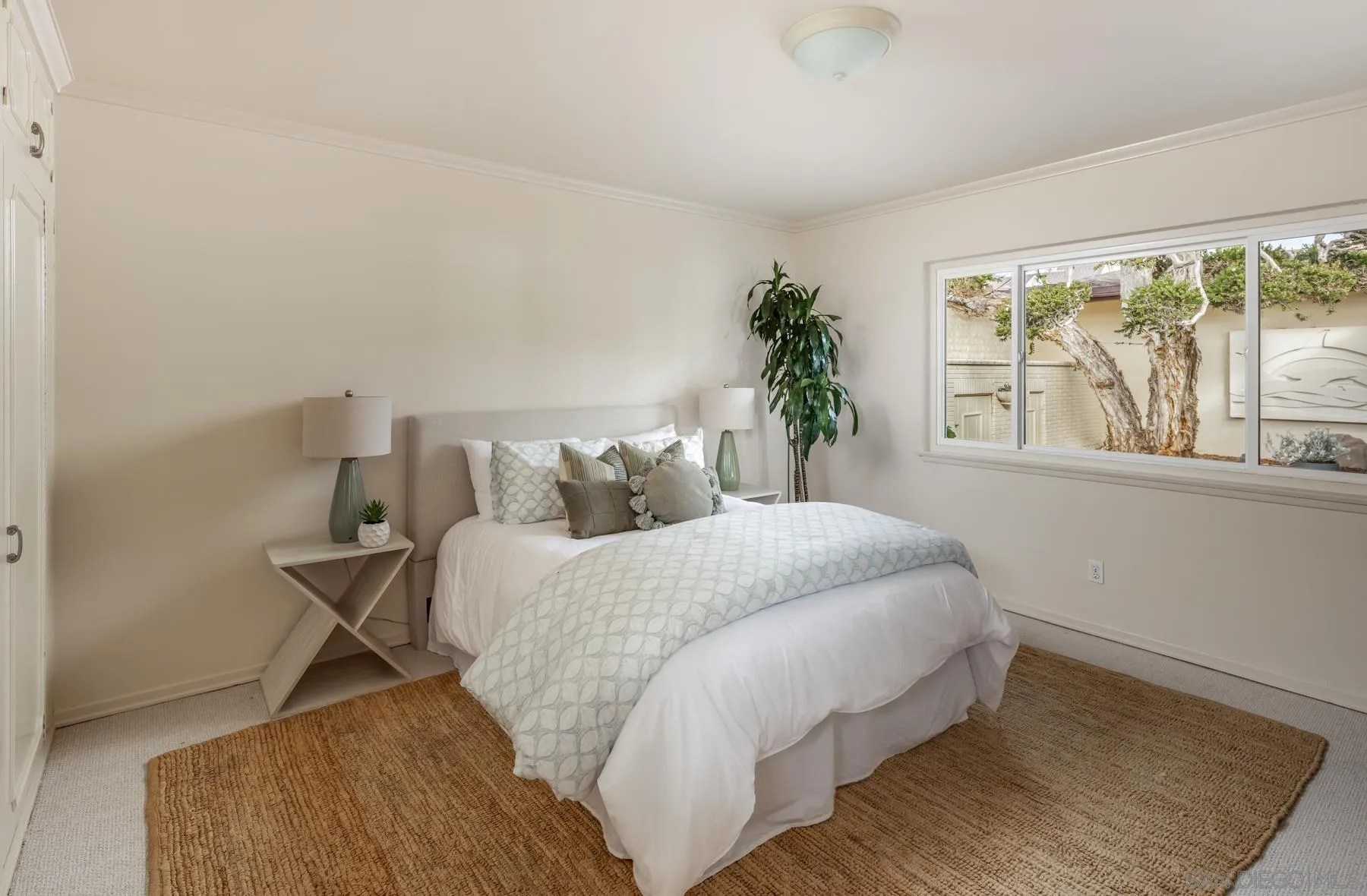 2977 Ocean Street Carlsbad, CA 92008 - Photo 24 of 44 a bed sitting in a bedroom next to a window