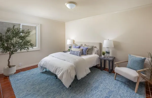 a bedroom with bed and a window