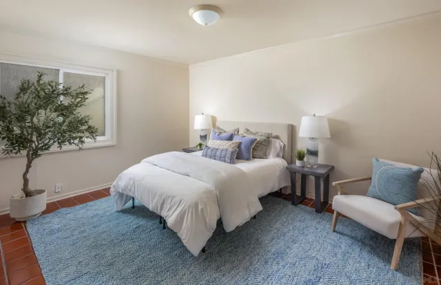 a bedroom with bed and a window