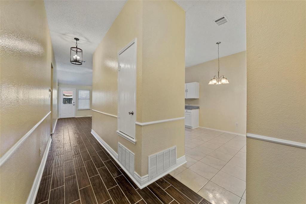 1002 Manassas Drive Forney, TX 75126 - Photo 14 of 26 a view of a hallway with wooden floor and staircase