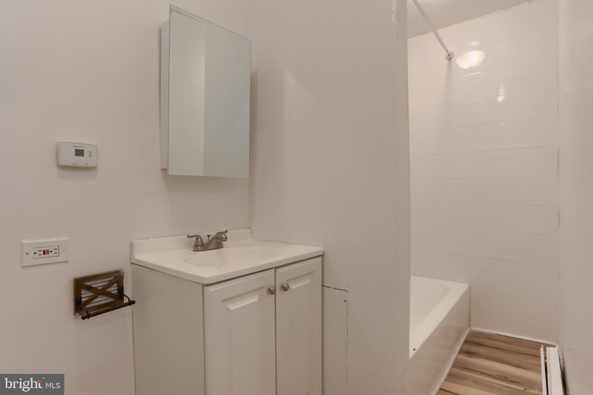 825 Scull Street Lebanon, PA 17046 - Photo 19 of 24 Full bathroom with tub and tiled shower surround.