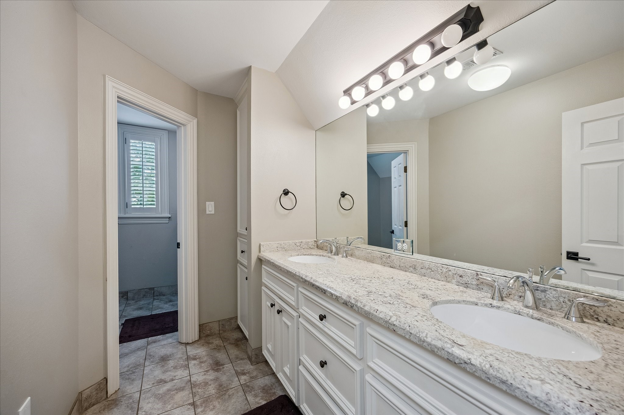 6358 Auden Street Houston, TX 77005 - Photo 35 of 50 a spacious bathroom with a granite countertop sink a mirror and a shower