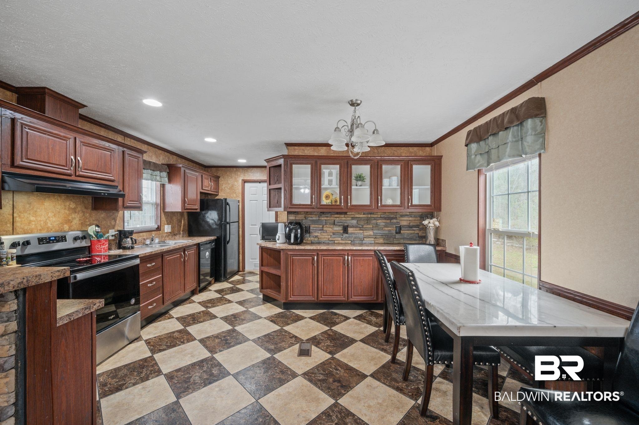 39908 T A Chastang Road Bay Minette, AL 36507 - Photo 6 of 20 Kitchen with a notable chandelier, open shelves, a sink, under cabinet range hood, and black appliances