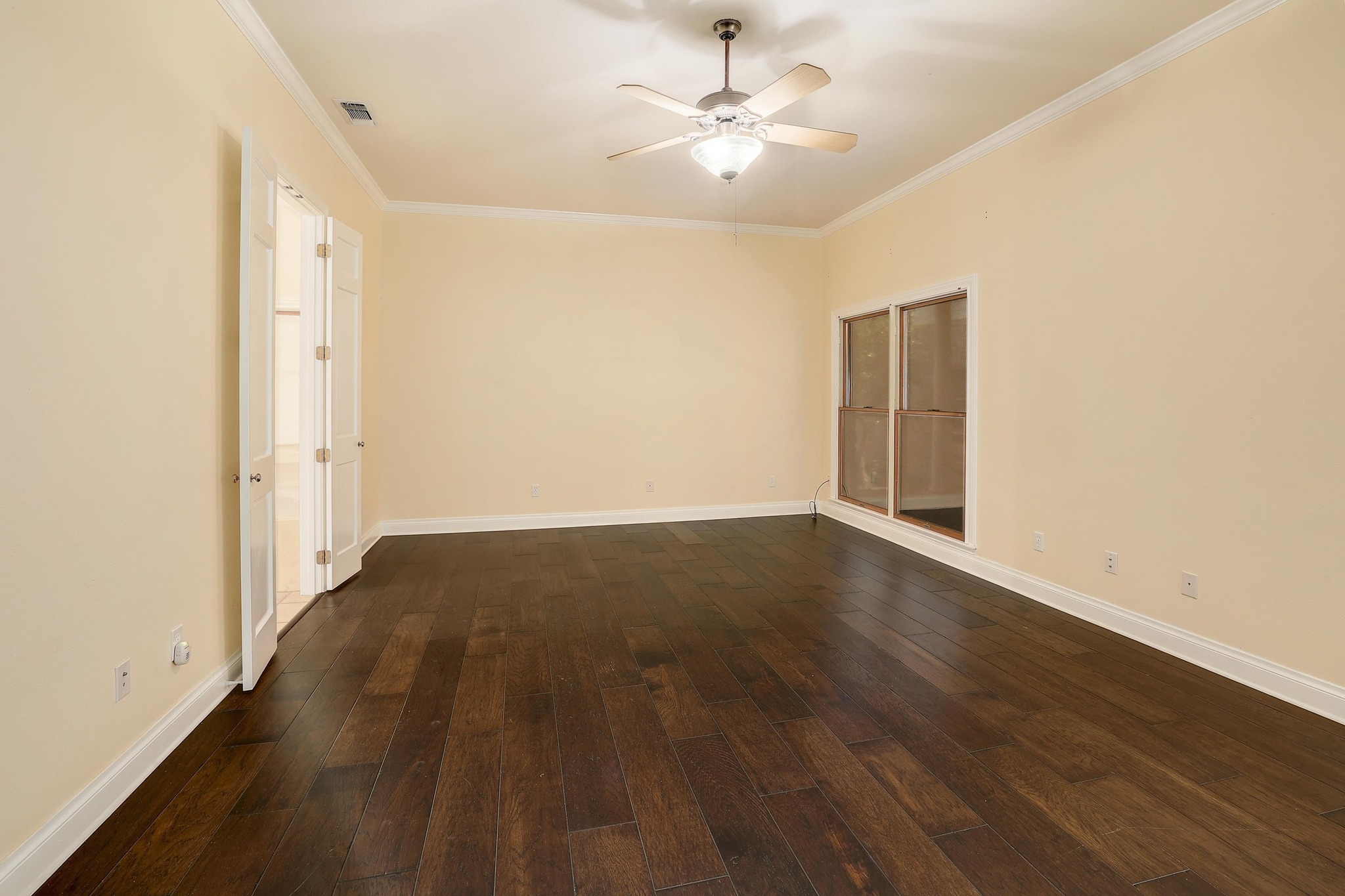 3900 Shell Road Georgetown, TX 78628 - Photo 17 of 40 Empty room featuring ornamental molding, dark wood-style floors, and a ceiling fan