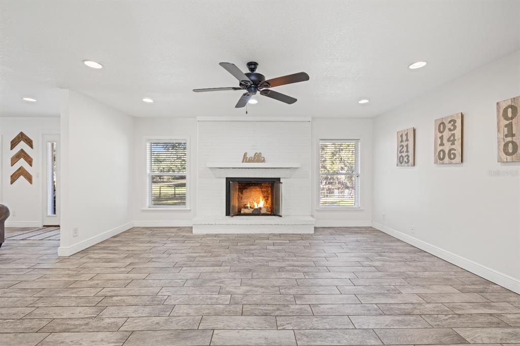 12414 Fort King Road Dade City, FL 33525 - Photo 12 of 60 a view of an empty room with a window and a fireplace