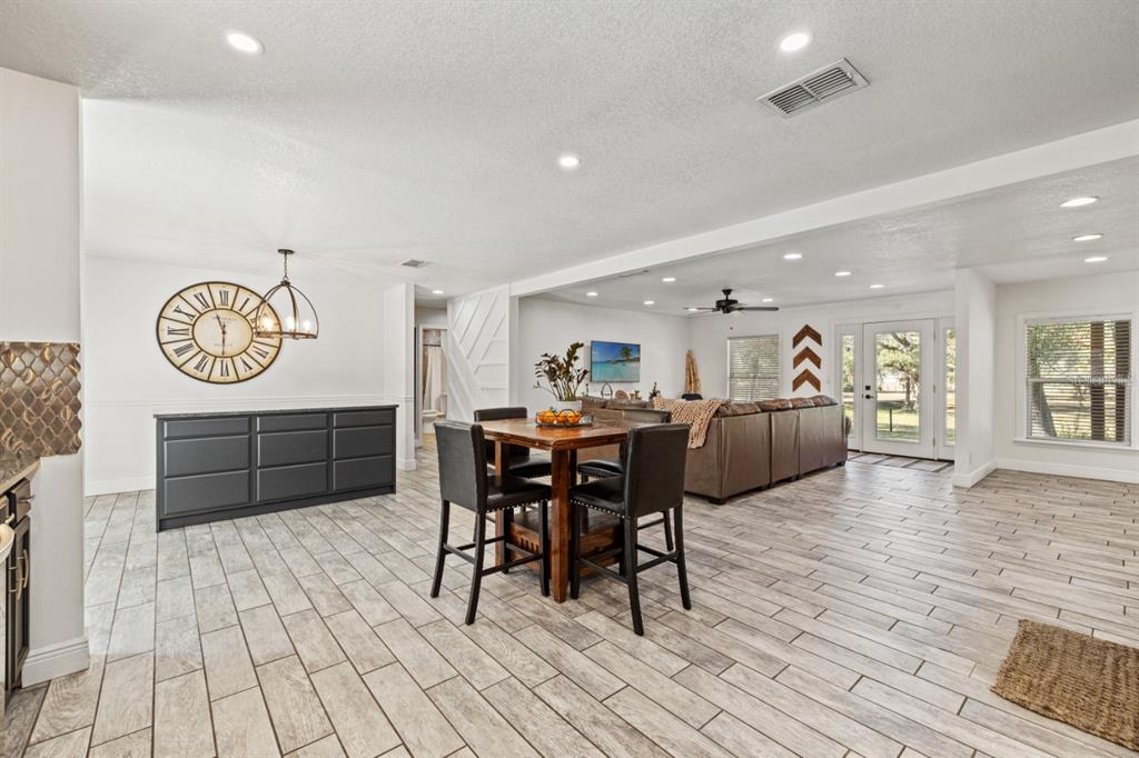 12414 Fort King Road Dade City, FL 33525 - Photo 20 of 60 a view of a a dining room with furniture window and wooden floor