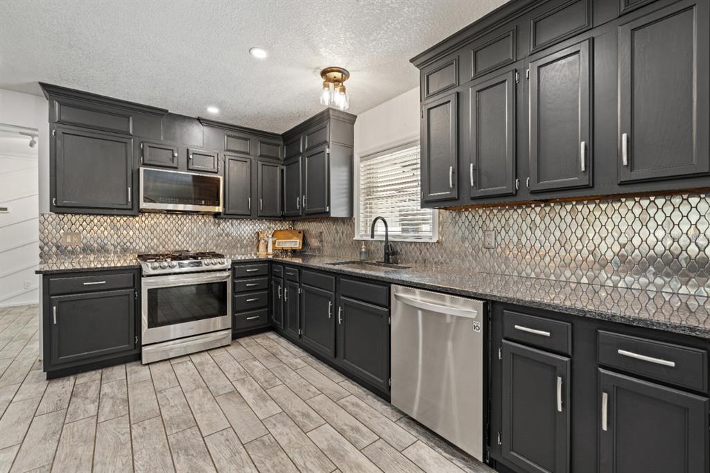 12414 Fort King Road Dade City, FL 33525 - Photo 21 of 60 a kitchen with a sink stove and microwave