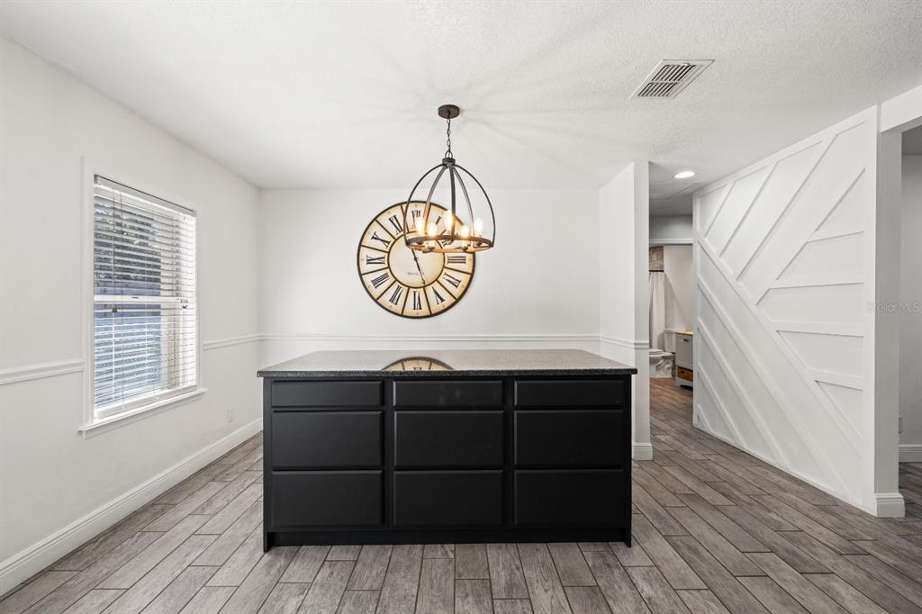 12414 Fort King Road Dade City, FL 33525 - Photo 22 of 60 a view of a storage & utility room with wooden floor