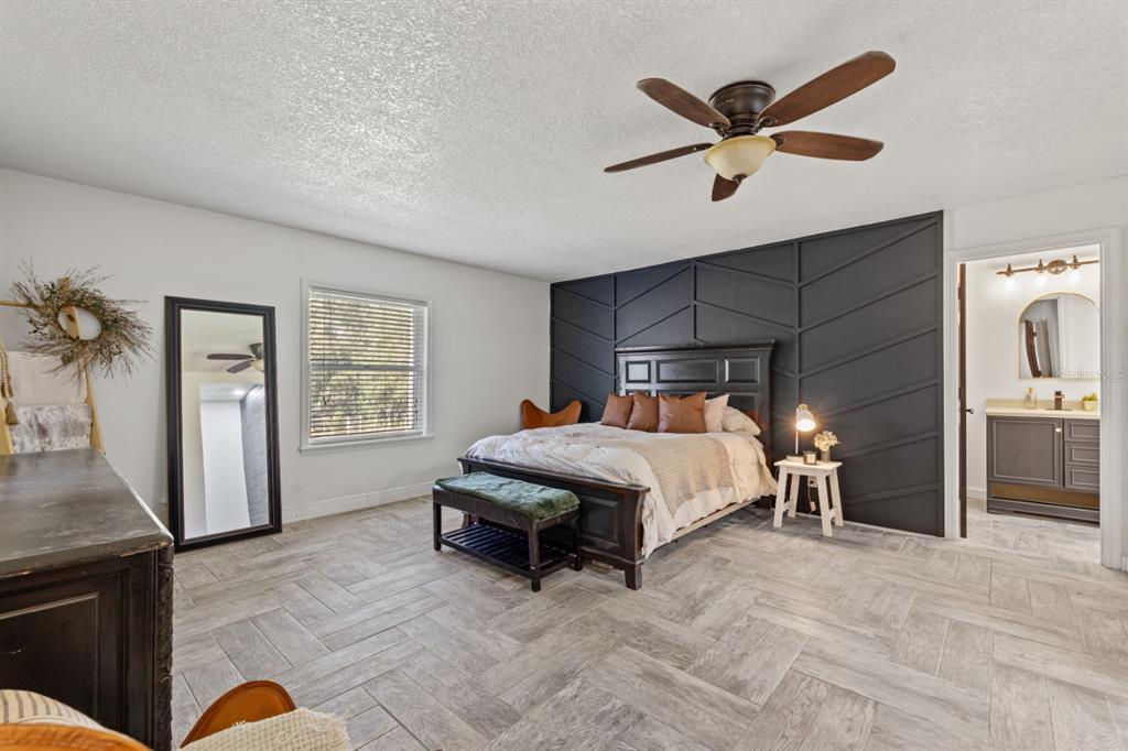 12414 Fort King Road Dade City, FL 33525 - Photo 28 of 60 a bed room with a bed and a ceiling fan