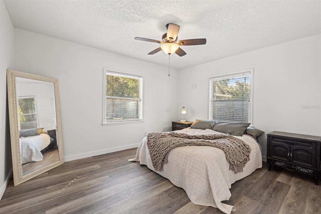 12414 Fort King Road Dade City, FL 33525 - Photo 36 of 60 a bedroom with a bed and a chandelier