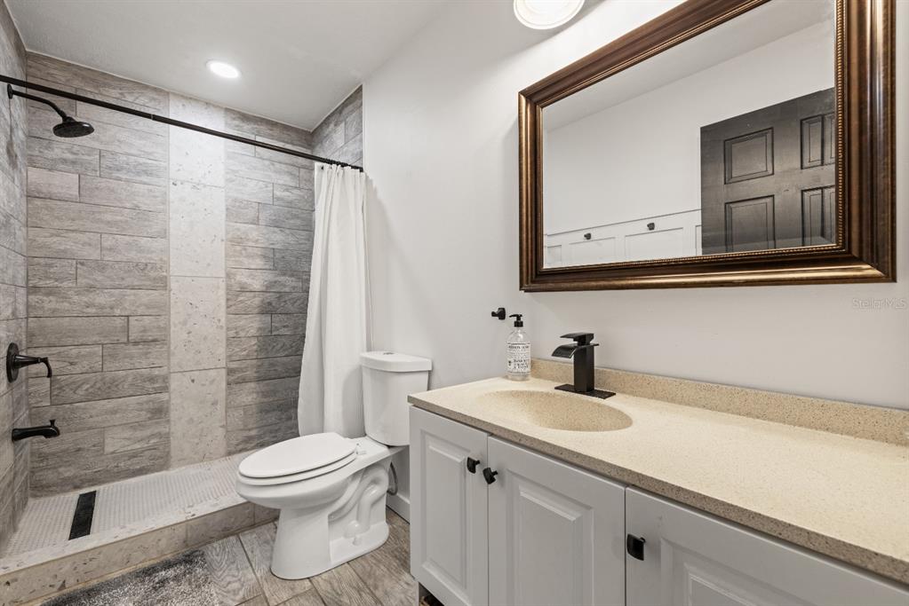 12414 Fort King Road Dade City, FL 33525 - Photo 38 of 60 a bathroom with a sink a toilet and shower