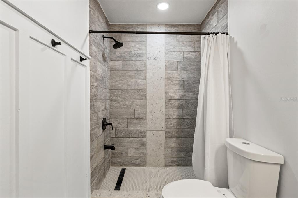 12414 Fort King Road Dade City, FL 33525 - Photo 39 of 60 a bathroom with a shower and a toilet