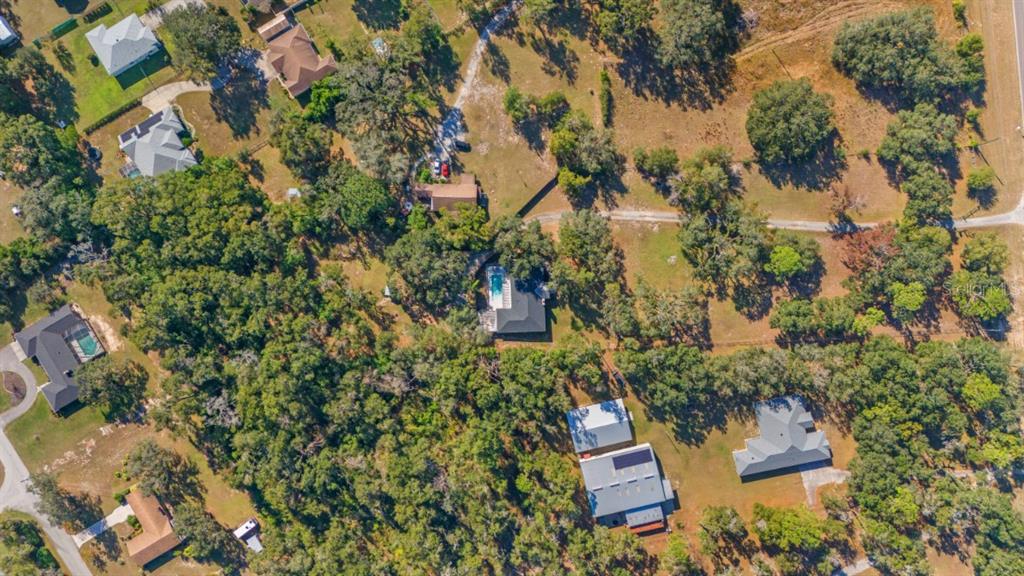 12414 Fort King Road Dade City, FL 33525 - Photo 4 of 60 an aerial view of residential house with outdoor space and trees all around