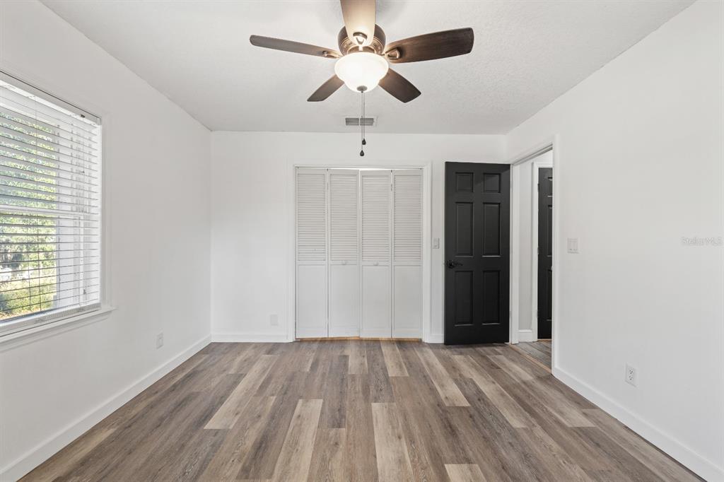 12414 Fort King Road Dade City, FL 33525 - Photo 41 of 60 wooden floor in an empty room with a window