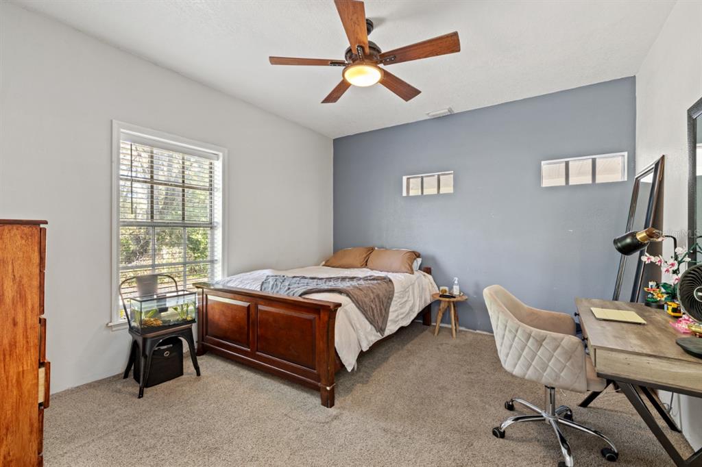 12414 Fort King Road Dade City, FL 33525 - Photo 42 of 60 a bedroom with a bed chair and a window