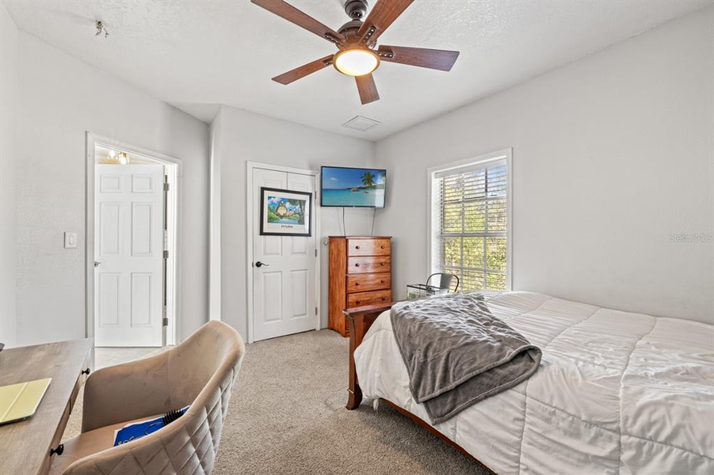 12414 Fort King Road Dade City, FL 33525 - Photo 43 of 60 a bedroom with a bed and a chandelier